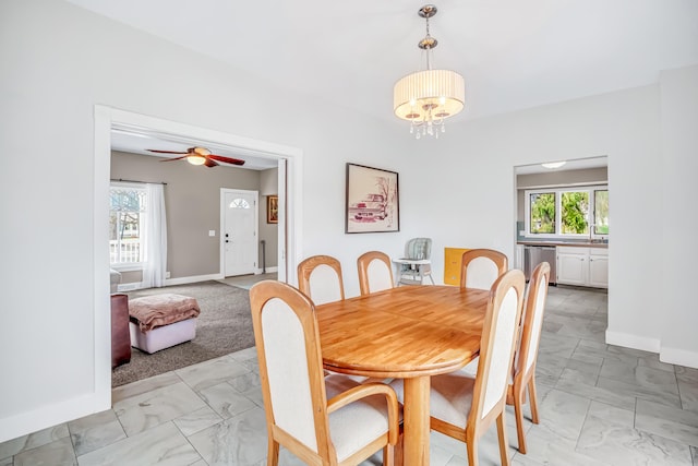 1856 N 56th Ave, Mears, MI 49436 - dining area with light marble finish flooring, plenty of natural light, a chandelier, and a ceiling fan