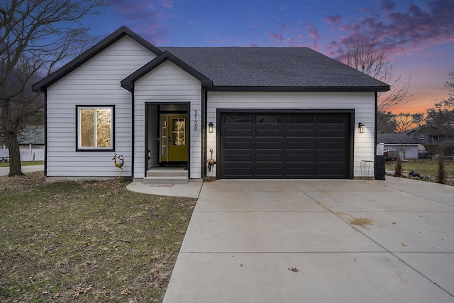 2128 Sampson Ave, Muskegon, MI 49441 - view of front facade featuring concrete driveway, an attached garage, and a shingled roof