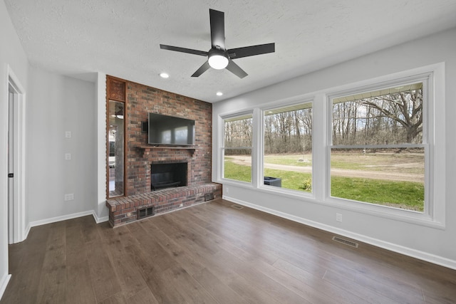 unfurnished living room featuring visible vents, baseboards, and ceiling fan