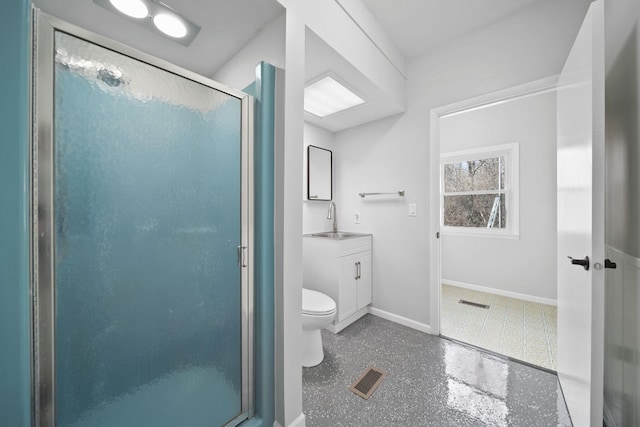 bathroom with toilet, a stall shower, vanity, baseboards, and visible vents