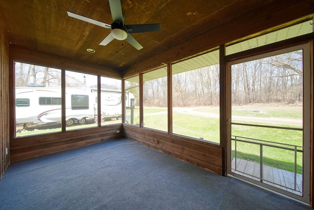 unfurnished sunroom featuring a ceiling fan