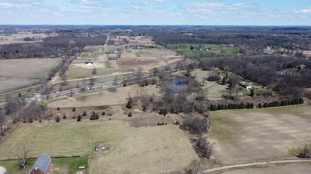 birds eye view of property with a rural view