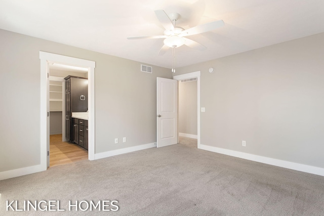 920 W Savidge St Unit 14, Spring Lake, MI 49456 - unfurnished bedroom featuring light carpet and a ceiling fan