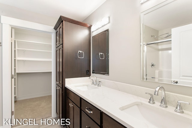 920 W Savidge St Unit 14, Spring Lake, MI 49456 - bathroom with double vanity and a spacious closet