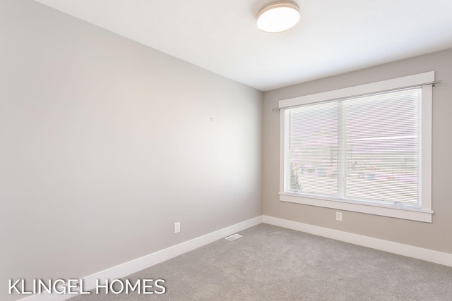920 W Savidge St Unit 14, Spring Lake, MI 49456 - spare room with baseboards and light carpet