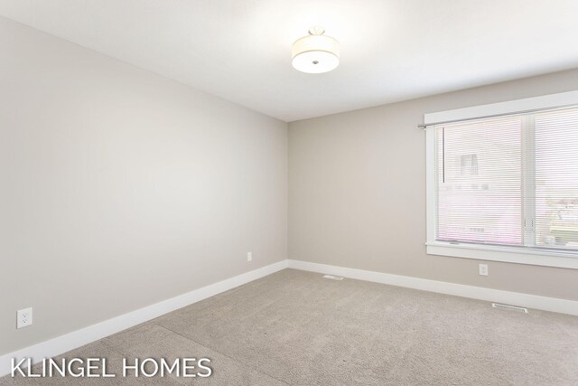 920 W Savidge St Unit 14, Spring Lake, MI 49456 - unfurnished room with carpet flooring and baseboards