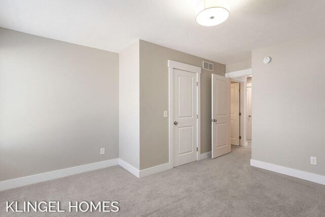920 W Savidge St Unit 14, Spring Lake, MI 49456 - unfurnished bedroom with light colored carpet