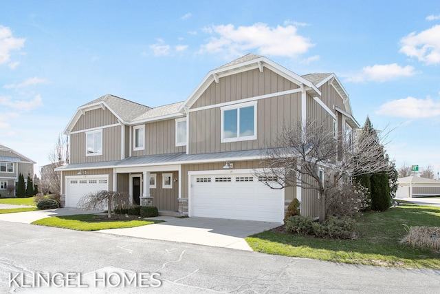 920 W Savidge St Unit 14, Spring Lake, MI 49456 - view of front of property featuring a standing seam roof, driveway, an attached garage, and roof with shingles