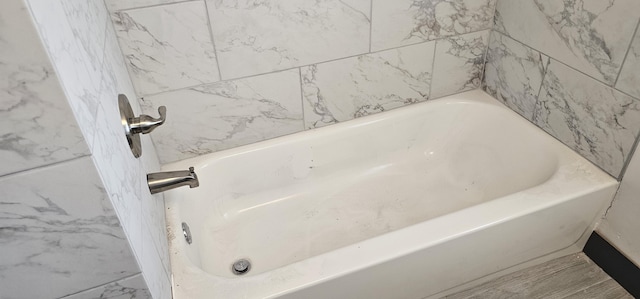 full bath featuring a tub to relax in