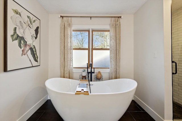 7101 River Glen Dr, Caledonia, MI 49316 - bathroom with baseboards, a freestanding bath, tile patterned flooring, and a stall shower