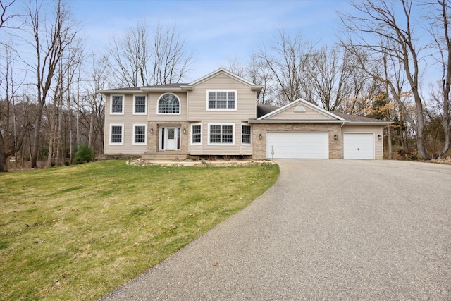 7101 River Glen Dr, Caledonia, MI 49316 - colonial-style house with an attached garage, driveway, and a front lawn