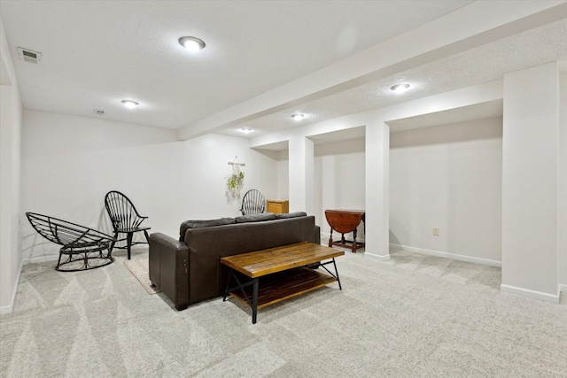 7101 River Glen Dr, Caledonia, MI 49316 - living area with light carpet, visible vents, baseboards, and a textured ceiling