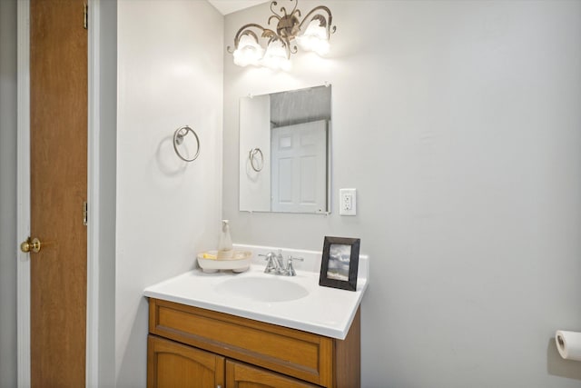 7101 River Glen Dr, Caledonia, MI 49316 - bathroom featuring an inviting chandelier and vanity