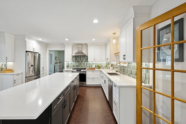 7101 River Glen Dr, Caledonia, MI 49316 - kitchen with a large island, white cabinetry, wall chimney exhaust hood, stainless steel appliances, and a sink
