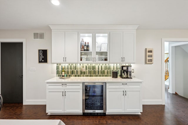 7101 River Glen Dr, Caledonia, MI 49316 - bar with visible vents, baseboards, wet bar, dark wood-type flooring, and beverage cooler