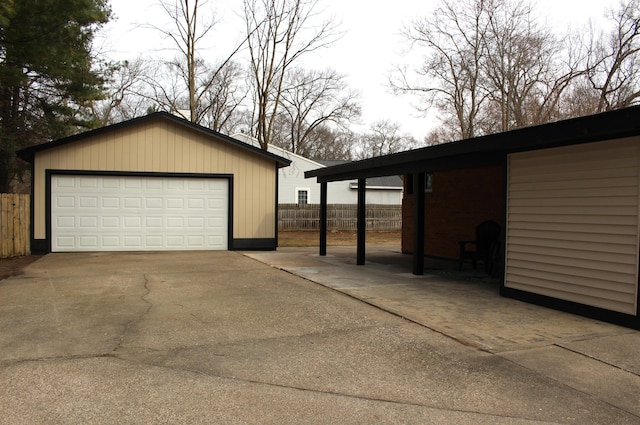 detached garage featuring fence