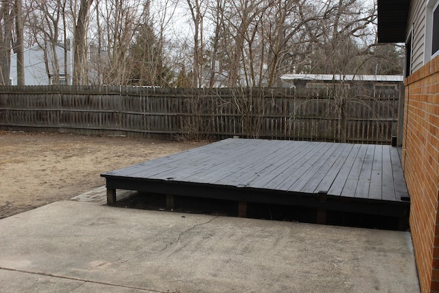 deck with a fenced backyard and a patio area