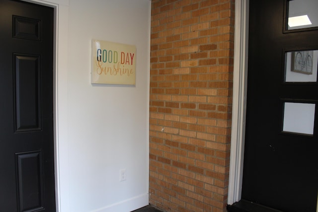doorway to property with brick siding