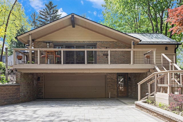 2891 Gale Rd, Ann Arbor, MI 48105 - view of front of home featuring brick siding, driveway, an attached garage, stairway, and a balcony