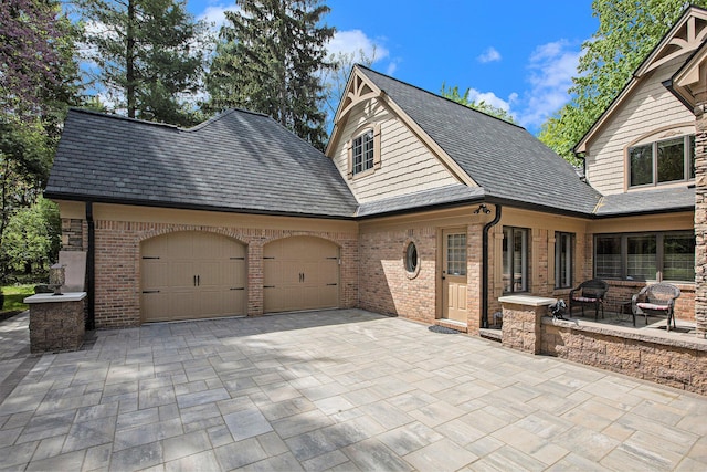 2891 Gale Rd, Ann Arbor, MI 48105 - view of patio featuring an attached garage and decorative driveway