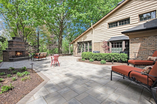 2891 Gale Rd, Ann Arbor, MI 48105 - view of patio featuring an outdoor stone fireplace