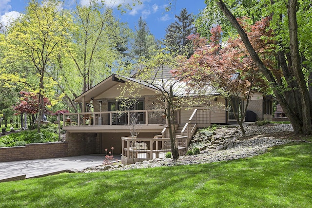 2891 Gale Rd, Ann Arbor, MI 48105 - back of house with brick siding, driveway, a yard, and an attached garage