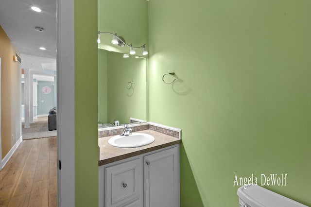 4087 Baldwin St, Hudsonville, MI 49426 - bathroom with toilet, wood finished floors, and vanity