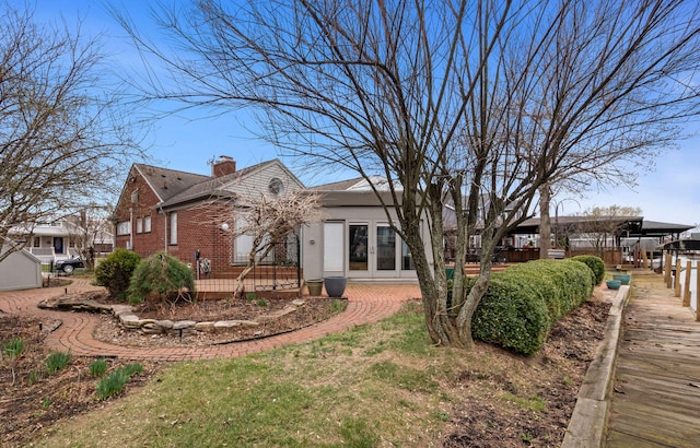 14511 Harbor St, Detroit, MI 48215 - back of house featuring brick siding and a chimney