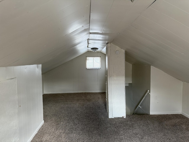 additional living space with carpet flooring and lofted ceiling
