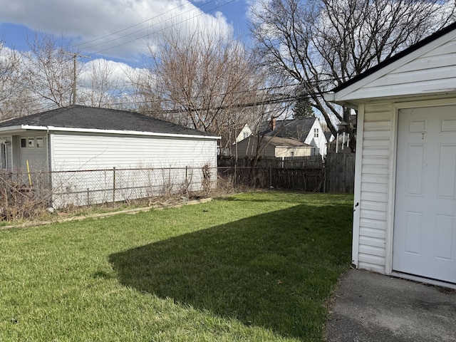 view of yard with fence and an outdoor structure