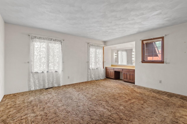 4675 Treat Hwy, Adrian, MI 49221 - unfurnished bedroom featuring multiple windows, carpet flooring, and a textured ceiling