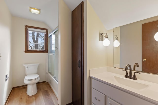 4675 Treat Hwy, Adrian, MI 49221 - full bathroom featuring toilet, wood finished floors, vanity, lofted ceiling, and shower / bath combination with glass door