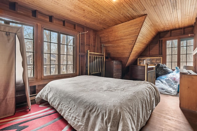 bedroom featuring wood-type flooring, wooden ceiling, vaulted ceiling, and wood walls