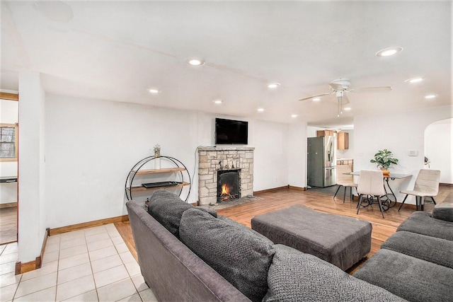 5353 Plum St, Coloma, MI 49038 - living area featuring ceiling fan, arched walkways, a fireplace, recessed lighting, and light wood-type flooring
