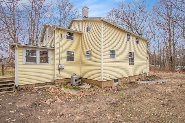 5353 Plum St, Coloma, MI 49038 - view of home's exterior with a central AC unit and a chimney