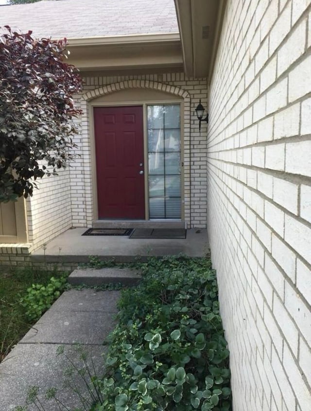 property entrance with brick siding