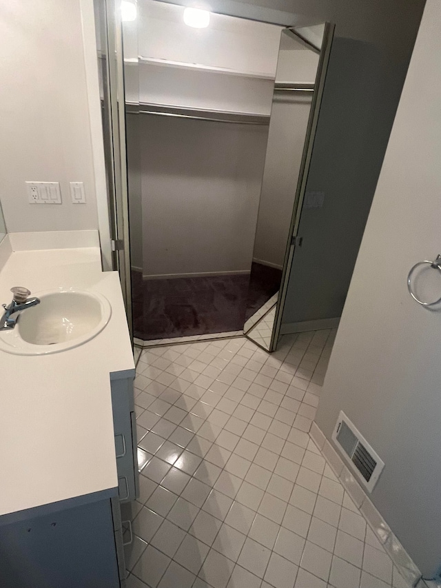 bathroom featuring visible vents, tile patterned floors, and vanity