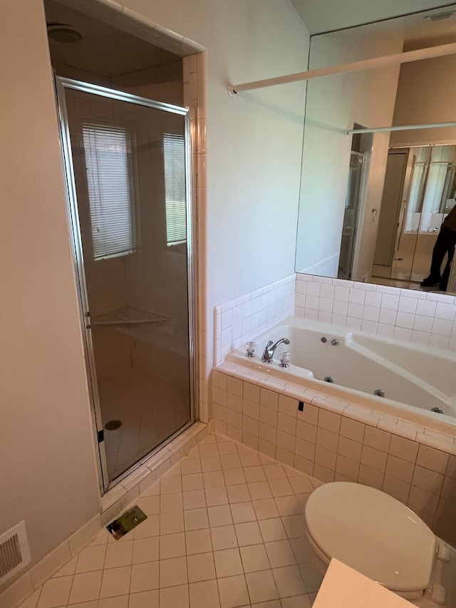 bathroom featuring a whirlpool tub, toilet, tile patterned flooring, and a stall shower