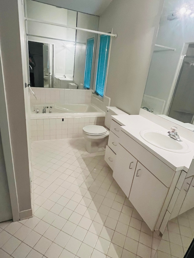 bathroom with a relaxing tiled tub, an enclosed shower, tile patterned floors, and toilet