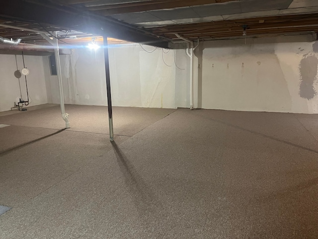 unfinished basement featuring electric panel