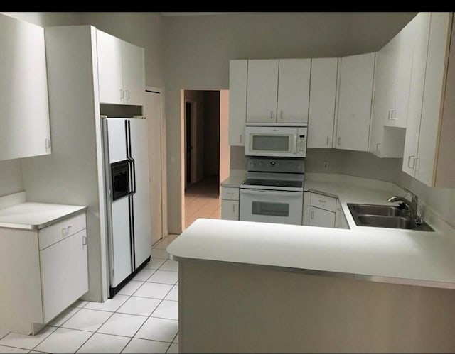 7355 Sherwood Crk, West Bloomfield, MI 48322 - kitchen featuring white appliances, a sink, a peninsula, light tile patterned floors, and light countertops