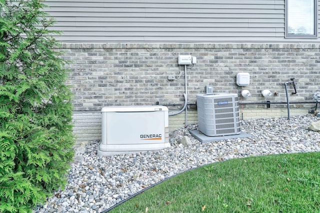 details with brick siding, a power unit, and central air condition unit