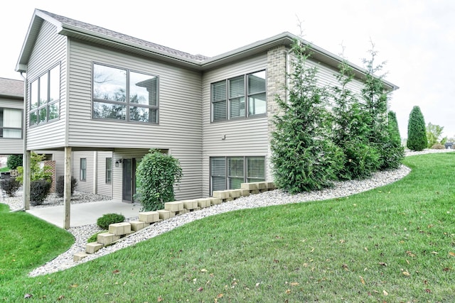 back of house with a yard and a patio area