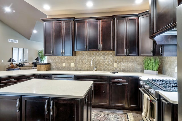 kitchen with visible vents, light countertops, dark brown cabinets, stainless steel appliances, and decorative backsplash