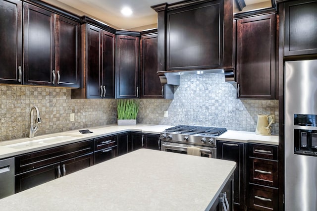 kitchen with light countertops, tasteful backsplash, appliances with stainless steel finishes, and a sink