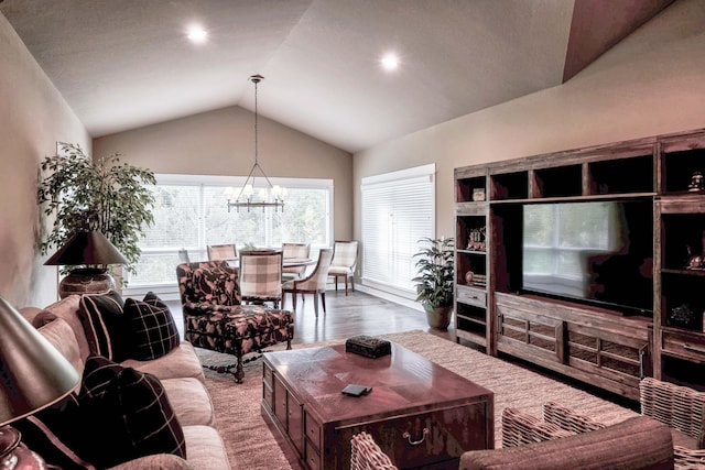 living area featuring wood finished floors, recessed lighting, a notable chandelier, and vaulted ceiling