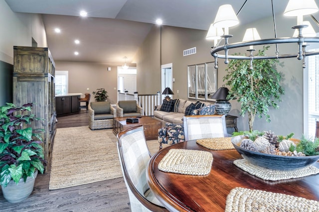 dining room featuring visible vents, recessed lighting, high vaulted ceiling, and wood finished floors