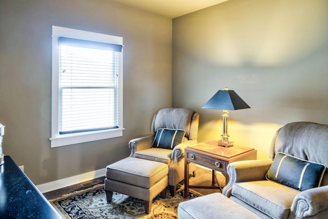sitting room featuring a wealth of natural light, wood finished floors, and baseboards