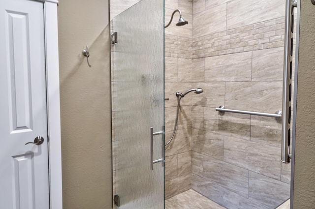 full bath with a stall shower and a textured wall
