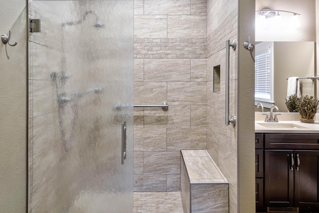 bathroom featuring vanity and a stall shower